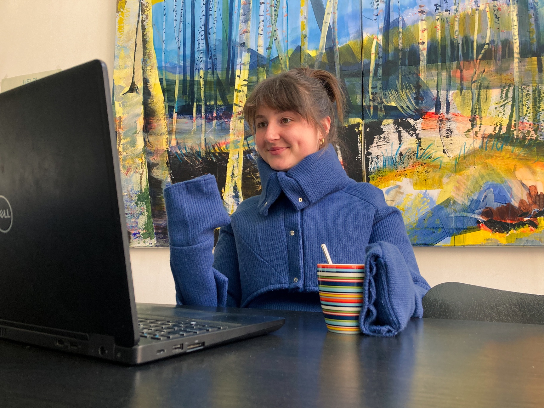 Charlotte working on a laptop in the blue Hotcharlie outfit.