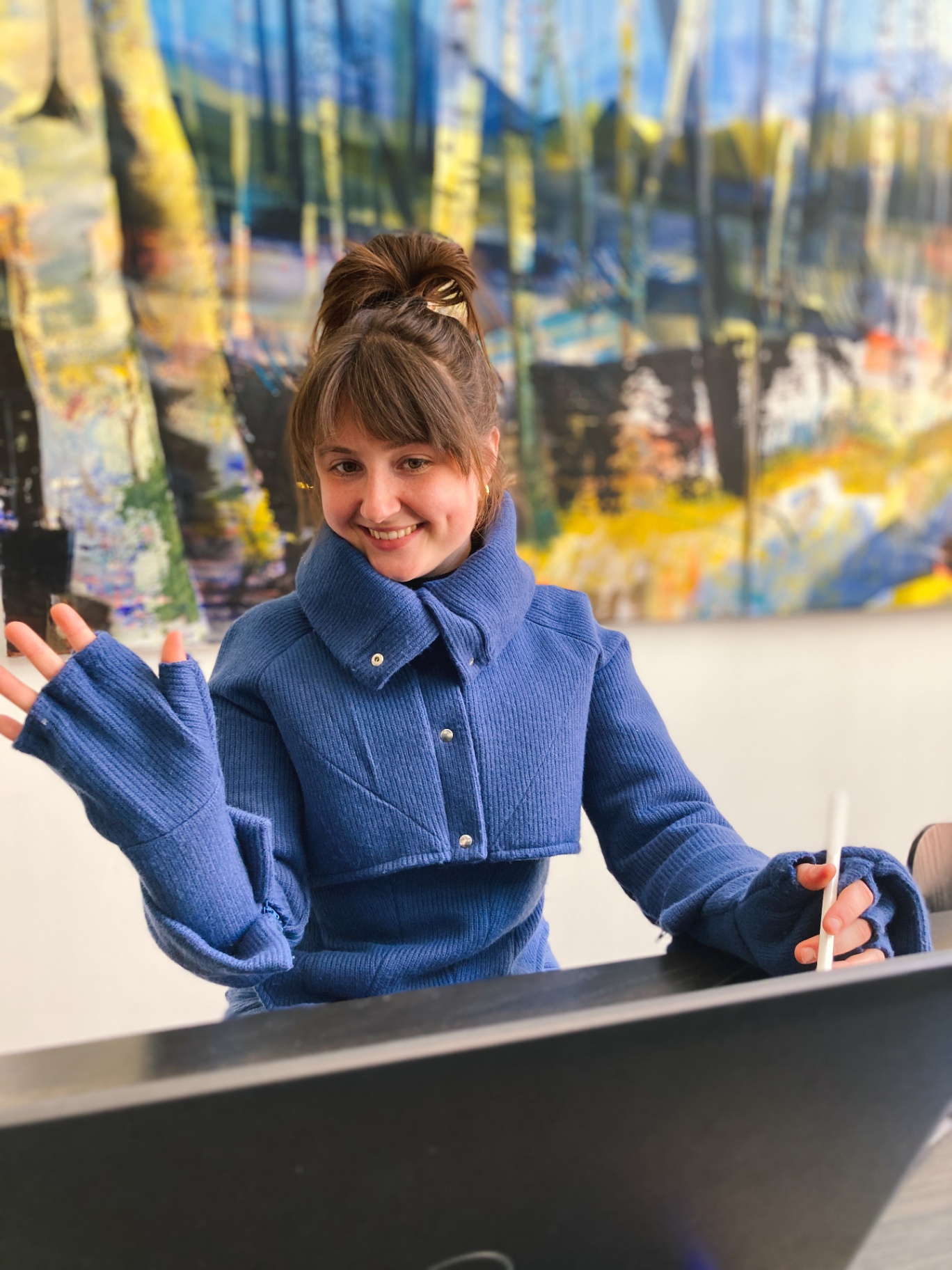 Charlotte at her desk in the blue Hotcharlie outfit.